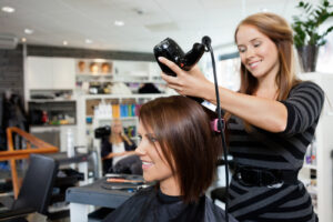 Avenue Five student drying clients hair