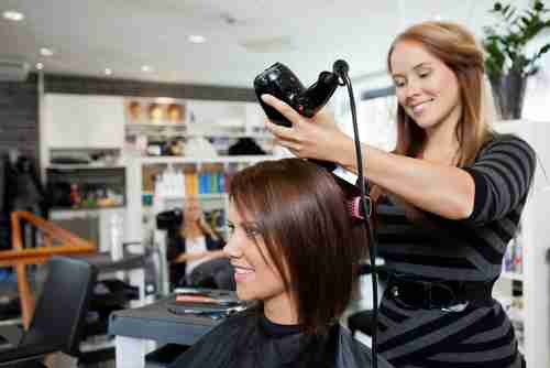 Avenue Five student drying clients hair
