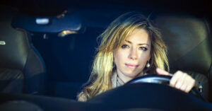 A woman driving a car.