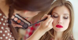 a woman getting her makeup done