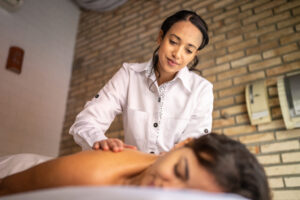 A massage therapist giving a client a back massage.