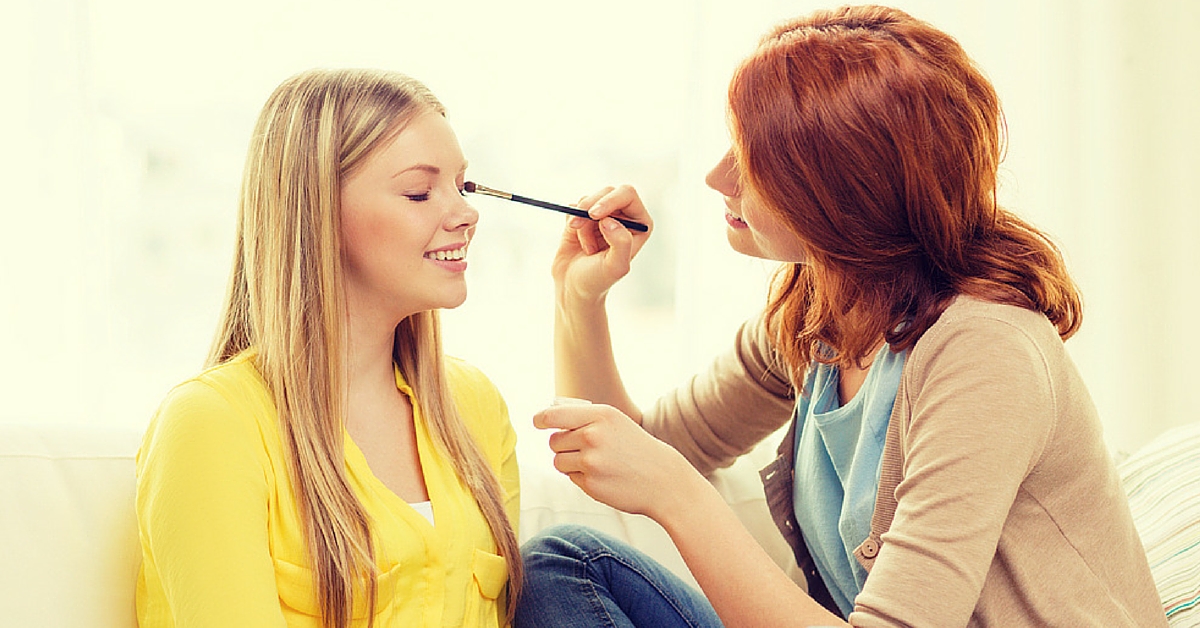 Esthetician applying makeup to a client for the esthetics program.