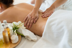 A massage therapist giving a client a back massage.