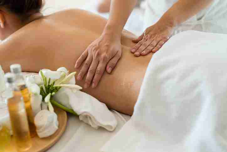 A massage therapist giving a client a back massage.