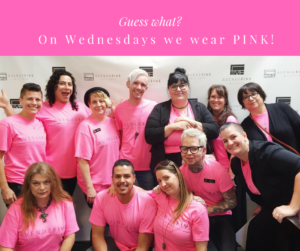 The Avenue Five team all wearing pink shirts and smiling for a group photo.