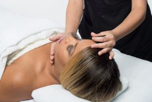 Esthetician carefully applying eyelash extensions to a client in a professional salon setting.