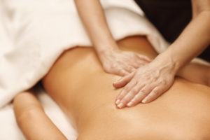 what makes a good massage therapist, woman receives back massage from therapist