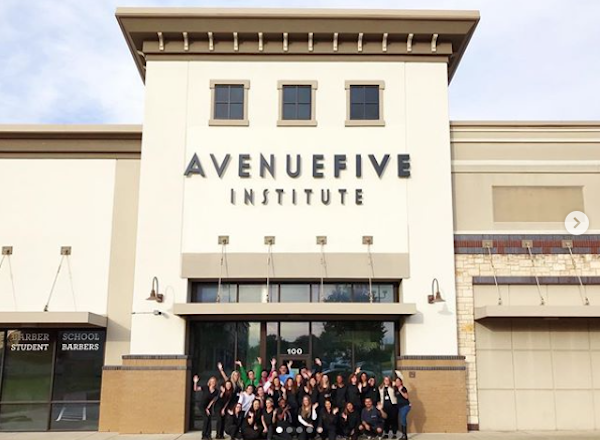 cosmetology and barber school students pose in front of Avenue Five Institute in Austin, Texas