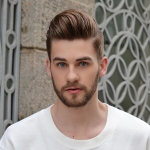 A blonde man with a fresh hair cut and trimmed beard.