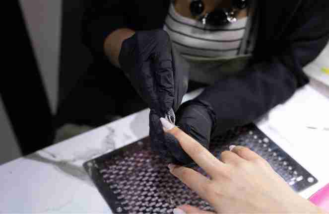 a woman getting her nails done