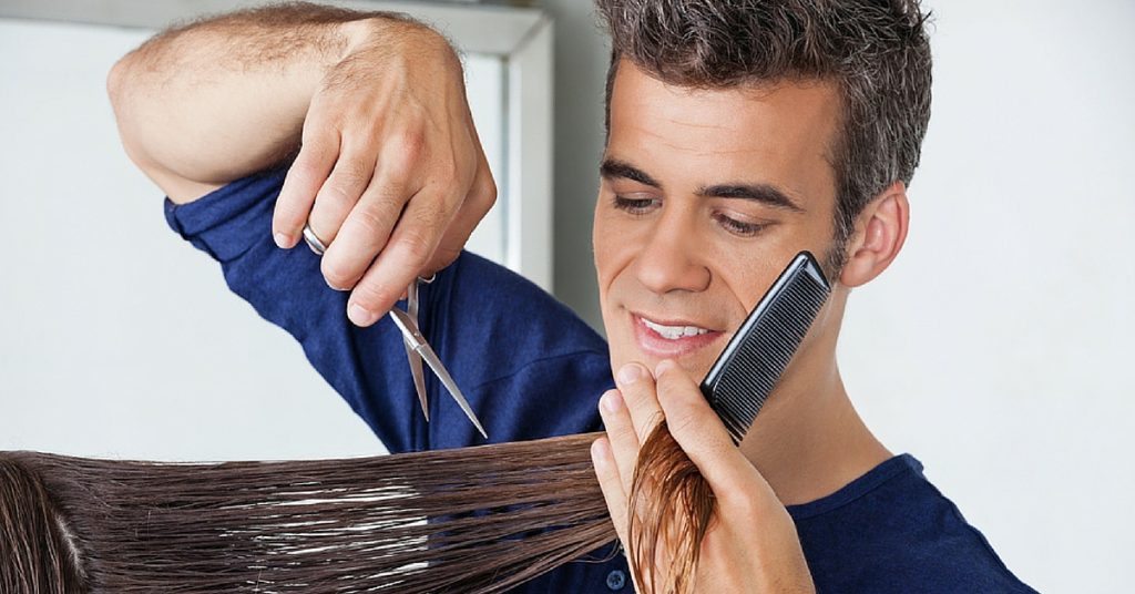 a man cutting a woman's hair