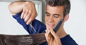 a man cutting a woman's hair