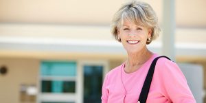 Old woman smiling outside of Avenue Five