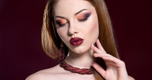 a model with red lipstick and darker eyeshadow