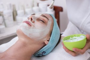a woman getting a face mask