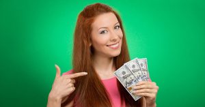 a woman smiling while holding money