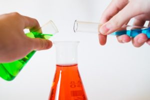 test tubes filled with green, red, and blue liquids