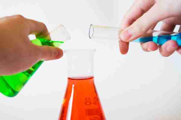 test tubes filled with green, red, and blue liquids