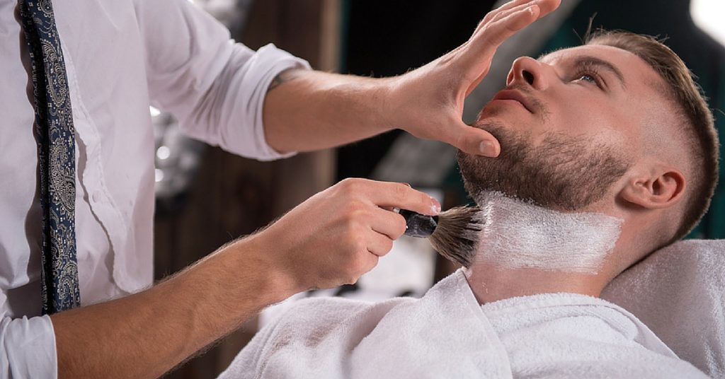 Barber student cutting hair in the salon at Avenue Five Institute, focused on honing their skills in a hands-on environment.