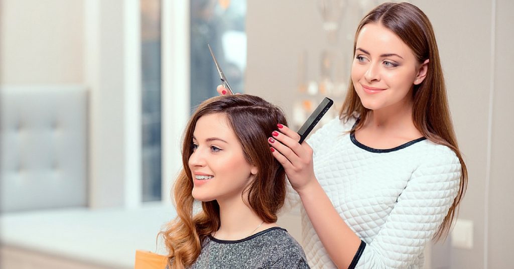 a woman cutting another woman's hair