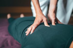 avenue five student giving a back massage