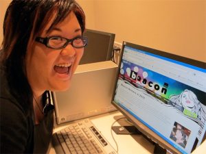 a happy woman at her computer