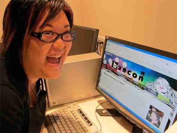 a happy woman at her computer