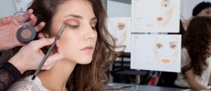 a woman getting her makeup done