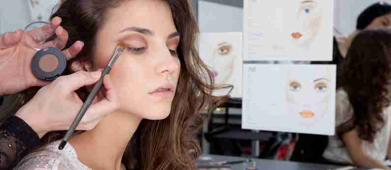 a woman getting her makeup done