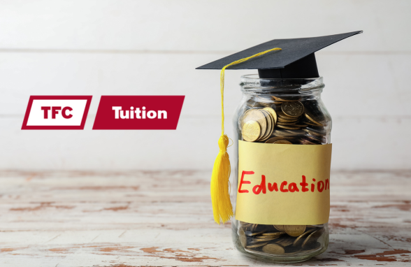 A glass jar with change in it and a graduation cap on top.