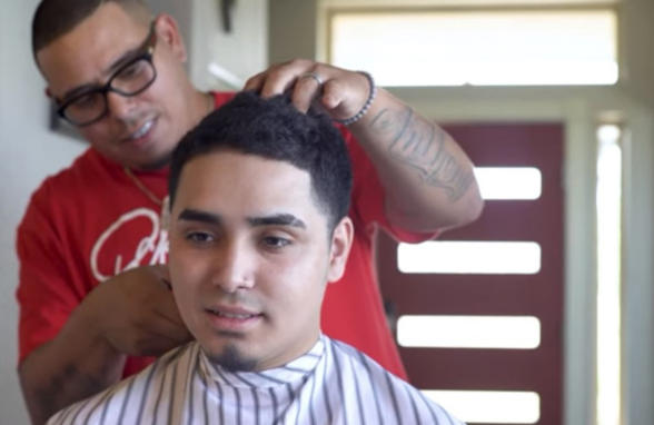 Barber student cutting hair in the salon at Avenue Five Institute, focused on honing their skills in a hands-on environment.