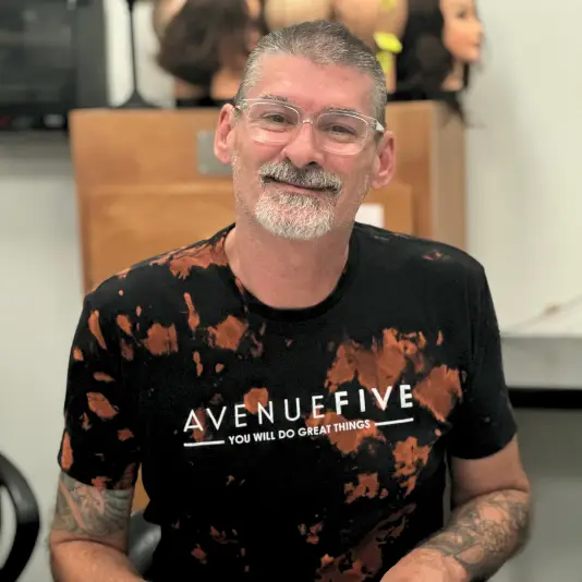 staff member with avenue five shirt